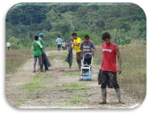 Figure 12. Community members maintaining hand-made airstrip at one of the communities from the interior.